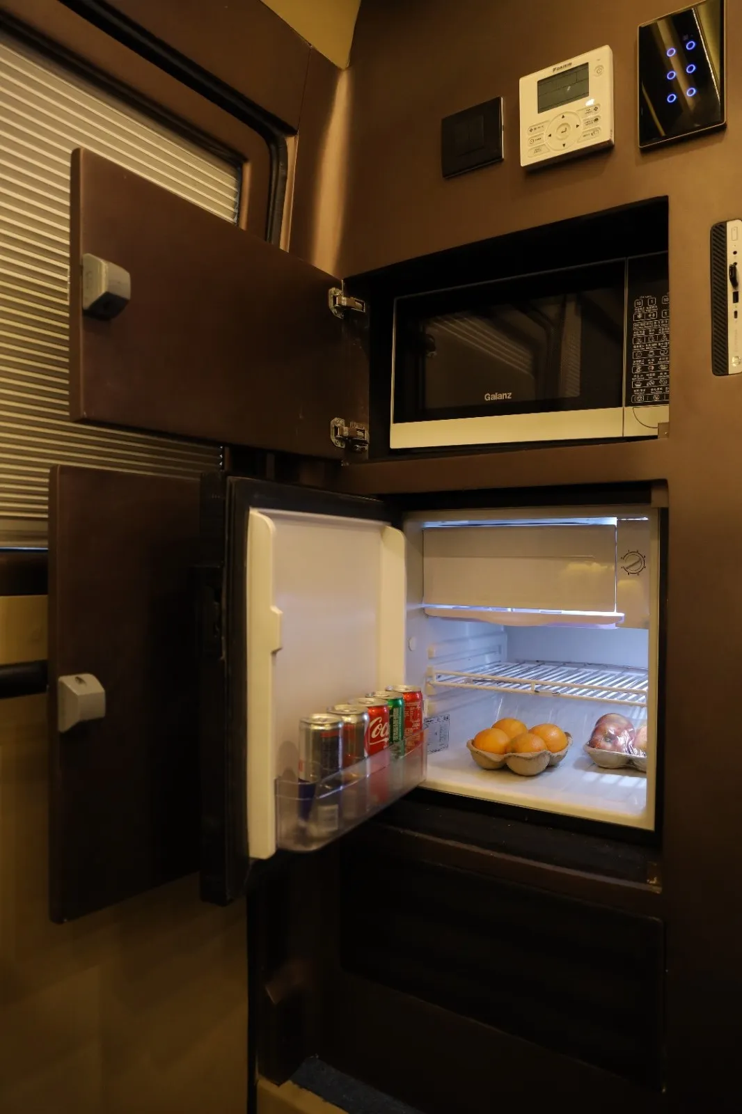 Mini fridge and microwave inside the 4 seater caravan in Chennai — stocked for the road