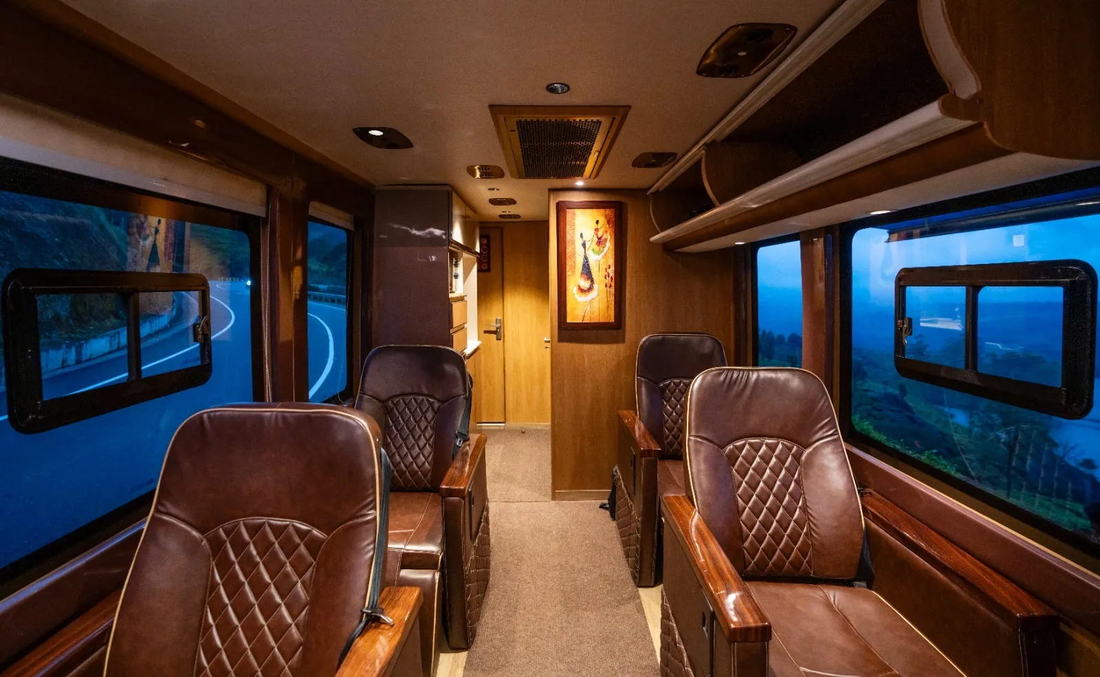 Compact 4 seater caravan interior in Chennai — AC lounge seating for four with large windows