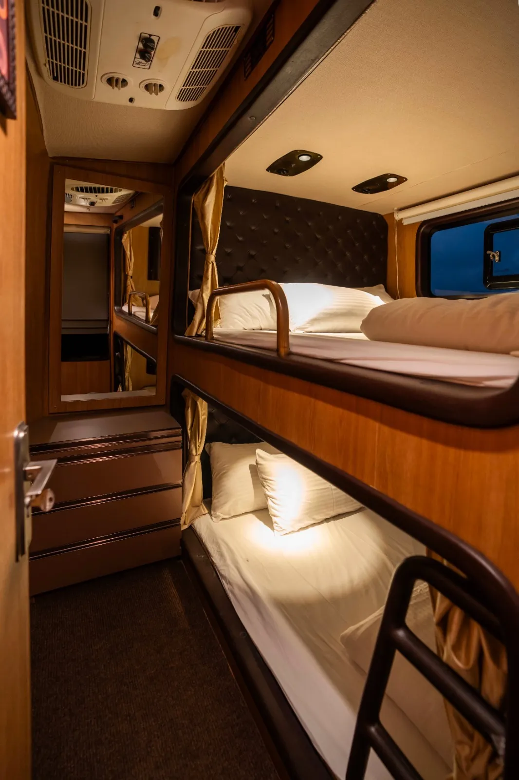 Bunk berths inside the 6 seater caravan in Chennai — made-up beds with reading lights