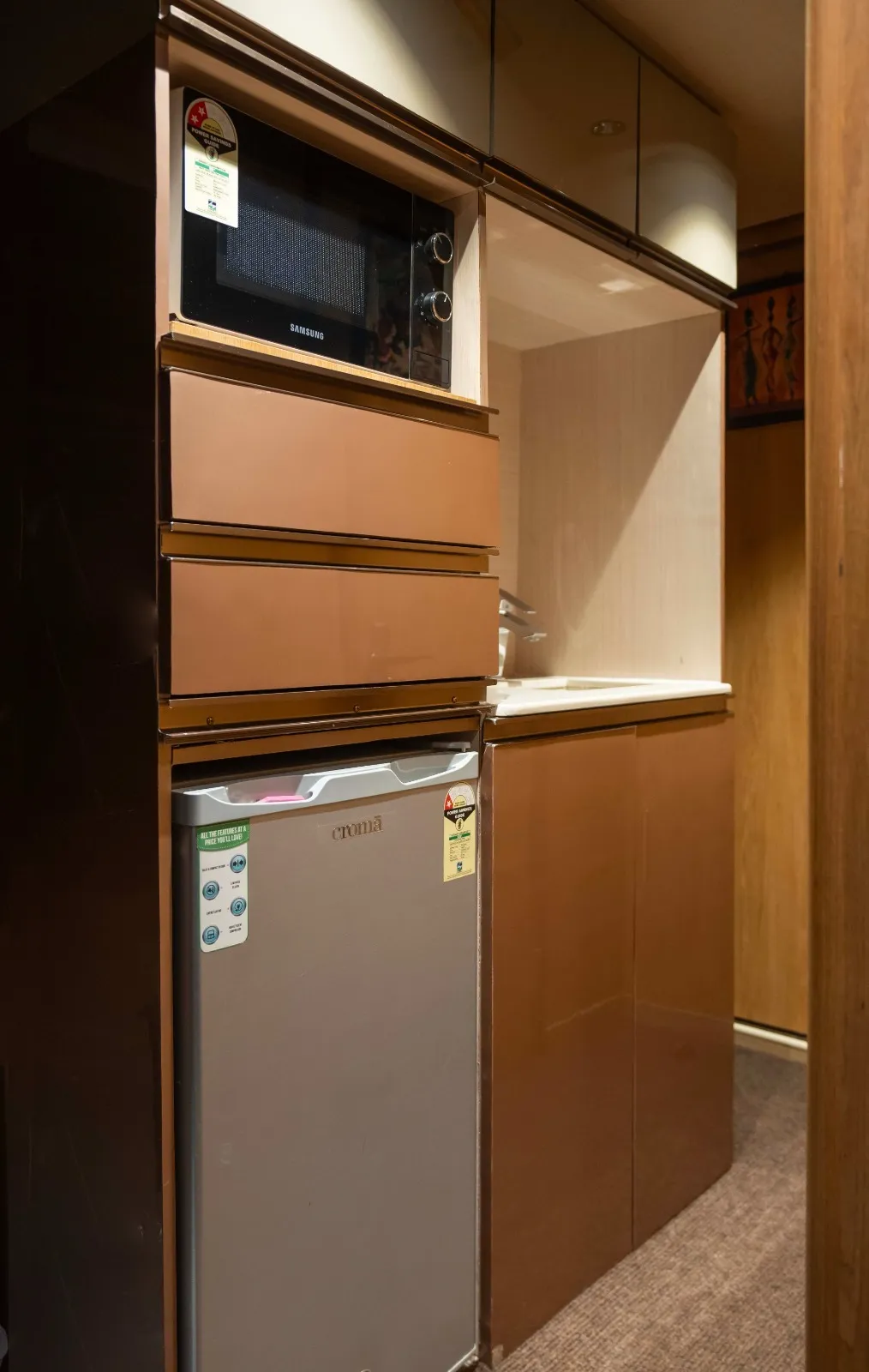 Kitchen inside the 6 seater caravan in Chennai — microwave, fridge and sink