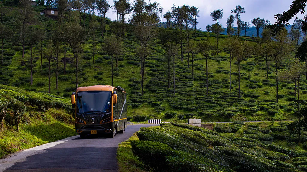 Caravan rental Chennai to Kodaikanal — caravan on a ghat road curve with mist over the valley