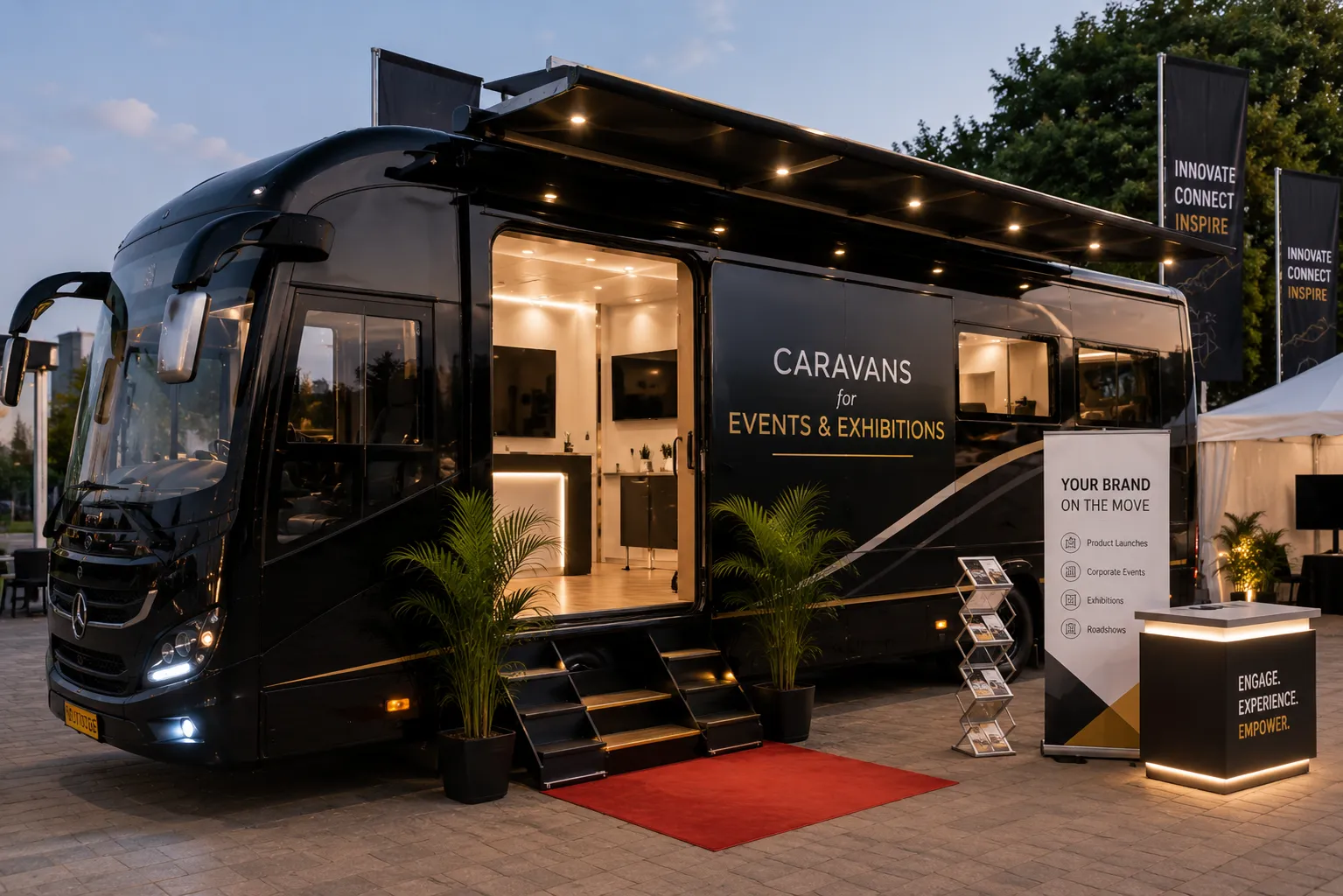 Caravan stationed at an outdoor Chennai event, branding panels mounted, evening crowd